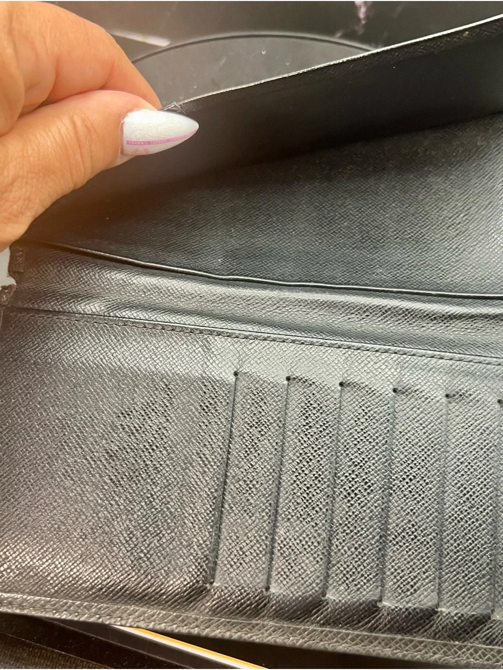 Louis Vuitton Taiga leather Brazza wallet in black. Fair condition. Unisex